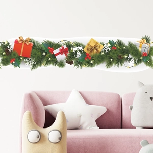 Christmas wall decal with pine branches, red berries and colorful gift boxes on white wall