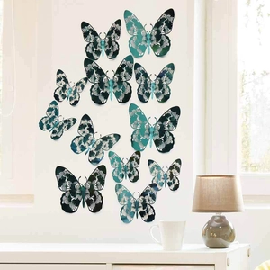 Detail of 12 blue 3D hollow butterfly wall stickers with floral patterns on white wall