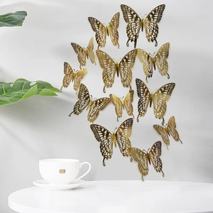 Golden 3D butterfly wall stickers with hollow patterns for elegant home decoration