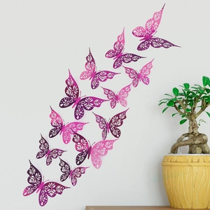 Detail of 3D pink and purple hollow butterfly wall stickers on a clean white background