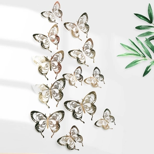Detailed view of hollow 3D gold butterfly wall stickers with intricate laser-cut wing patterns