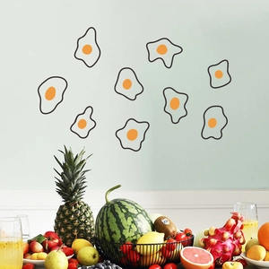Nine cute fried egg cartoon wall decals displayed on a soft green wall backdrop