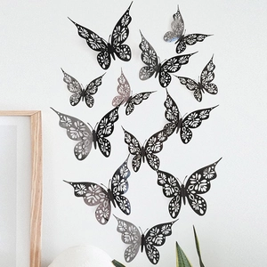 Close-up of 3D hollow butterfly wall stickers with intricate lace floral patterns on white wall