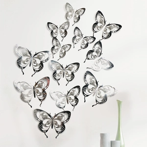 Macro detail of silver 3D hollow butterfly wall stickers with metallic carving texture