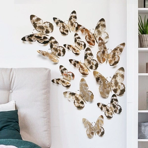 Detailed close-up of 3D metallic hollow butterfly wall stickers with intricate cutout patterns
