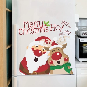 Cartoon Santa and reindeer Christmas window stickers on a white refrigerator door