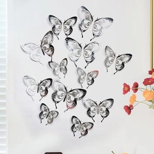 Set of 12 silver 3D hollow butterfly wall stickers with intricate cutout patterns