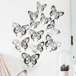 3D metallic silver hollow butterfly wall stickers displayed on white wall for home decor