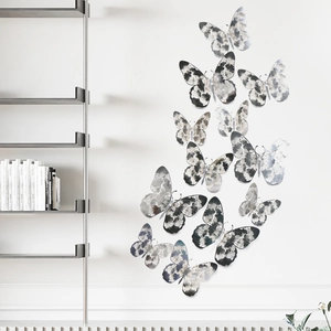 3D silver butterfly wall stickers with floral patterns on a white minimalist wall