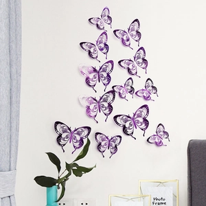 Detailed close-up of 3D purple hollow butterfly wall decals with metallic finish on a white wall