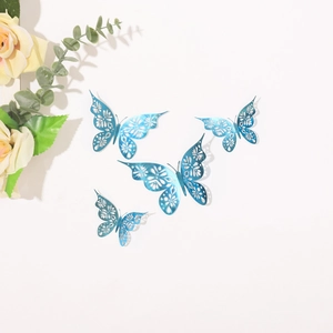 Detail of four royal blue hollow metal butterfly wall stickers with laser-cut floral patterns