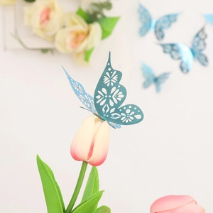 Macro shot of a blue 3D hollow butterfly wall sticker on a tulip for home decor