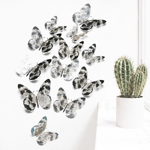 Detail view of 12pcs 3D hollow paper butterflies with artistic texture on a white wall
