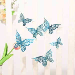 Detail of six dark blue hollow butterfly wall stickers with laser-cut patterns