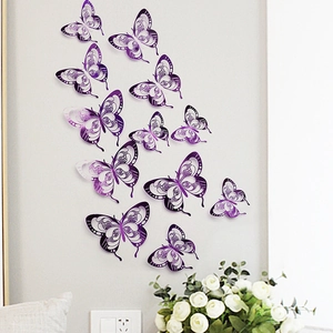 Detailed 3D hollow butterfly wall stickers in metallic purple on a light gray wall