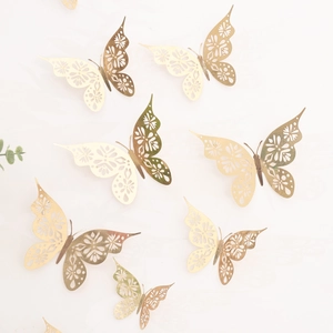 Detailed close-up of hollow gold butterflies with intricate laser-cut floral patterns