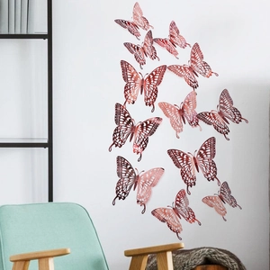 Macro detail of 12 rose gold 3d butterfly wall stickers with hollow carved pattern