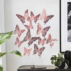 Detailed view of 3D hollow butterfly wall decals in rose gold on a white wall