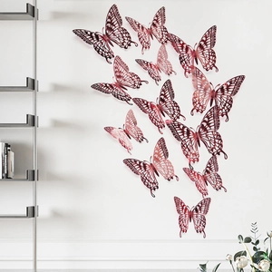 3D hollow rose gold butterfly wall stickers arranged in a flight pattern on a white wall