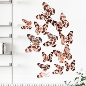 Macro shot of 12 rose gold 3D hollow butterfly wall stickers with intricate cutout patterns