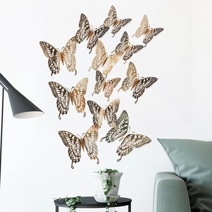 Detailed close-up of 12 gold 3D hollow butterflies on wall with refined cutout patterns