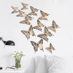 Set of 12 golden hollow butterfly wall stickers with 3D metallic texture in modern home decor