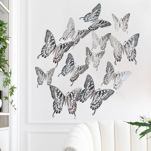 Detailed set of 12 hollow silver butterfly wall stickers in various sizes on a white wall