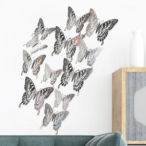 Set of 12 silver hollow 3D butterfly wall stickers in a modern home interior setting