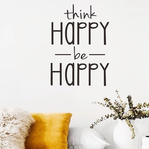 Detail of Think Happy Be Happy wall decal on white wall with home decor accessories