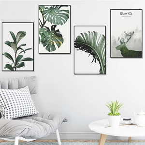 Modern Nordic wall art set featuring tropical green leaves and forest elk in black frames