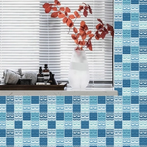 Close-up of blue and white geometric tile wall stickers in a modern bathroom setup