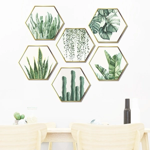 Detailed view of six hexagonal tropical plant wall stickers with golden frames on white wall
