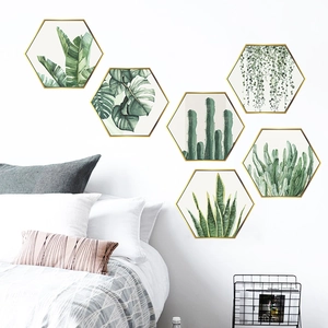Detailed view of six-piece golden hexagonal frames with tropical green plant wall stickers