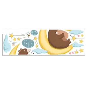 Detail of cartoon wall stickers showing sleeping bears on a moon with stars and clouds
