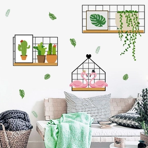 Detail view of decorative wall stickers featuring flamingos and tropical cactus plants