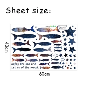 Wall sticker detail showing starry fish silhouettes with nebula texture and stars