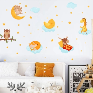 Nursery wall stickers featuring sleeping animals moon and stars in warm yellow tones