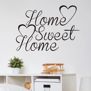 Home Sweet Home vinyl wall sticker with decorative hearts on a minimalist white wall