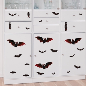 Halloween black bat wall stickers with red eyes on a white cabinet for festive home decor