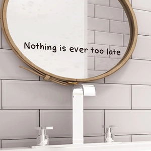 Modern wall mirror with wooden frame and leather strap featuring Nothing Is Ever Too Late quote