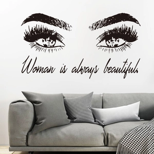 Modern wall sticker featuring long eyelashes and Woman is always beautiful quote
