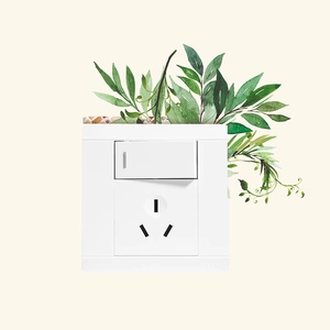 Detail of white minimalist wall switch and socket with decorative green plant wall sticker