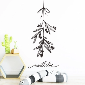 Minimalist hand-drawn black mistletoe wall sticker with bow on white interior wall