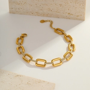 Detail of gold chain bracelet featuring pave-set cubic zirconia on rectangular links