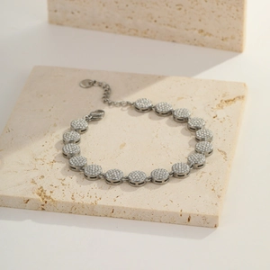 Detail of silver-tone chain bracelet with micro-paved zircon discs and lobster clasp