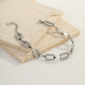 Silver chunky chain bracelet detail with polished links, zircon pavé, and lobster clasp