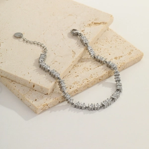 Detail of silver-tone stainless steel bracelet with sparkling square-cut zircons