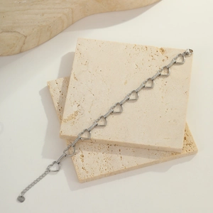 Detail of silver heart link bracelet in stainless steel with sparkling zircon stones