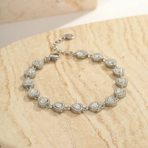 Macro shot of silver stainless steel heart link bracelet with zircons on stone surface