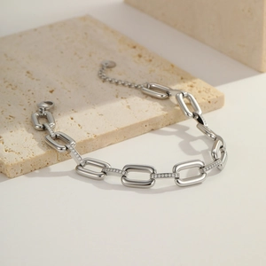 Macro shot of silver stainless steel thick link bracelet with sparkling zircon stones